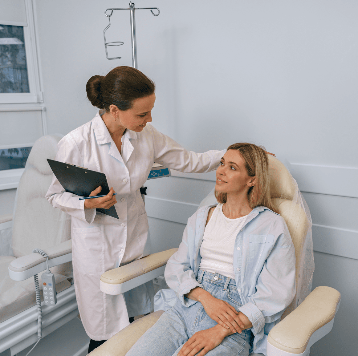 Doctor consulting with seated female patient.