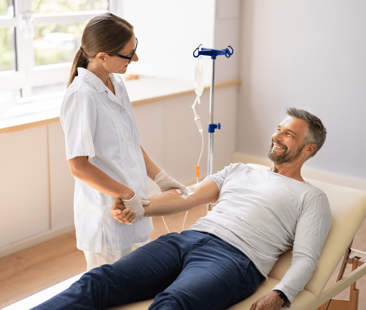 Nurse assisting patient with IV treatment.
