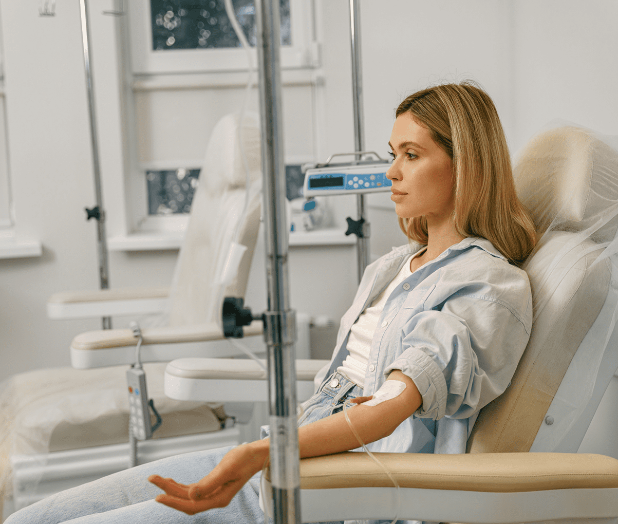 Woman receiving IV treatment in clinic.