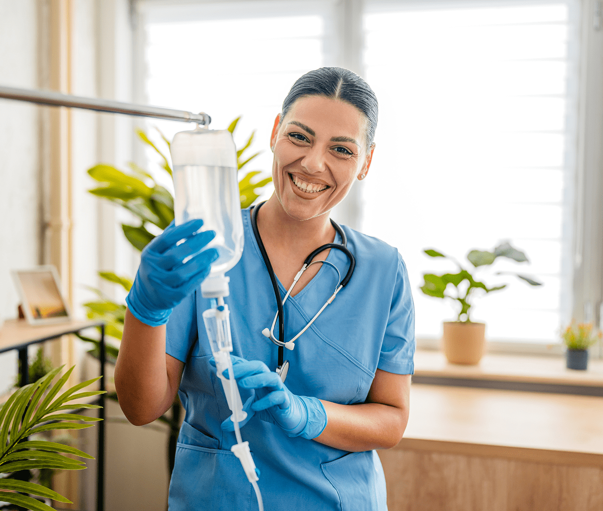 Smiling nurse holding an IV bag.