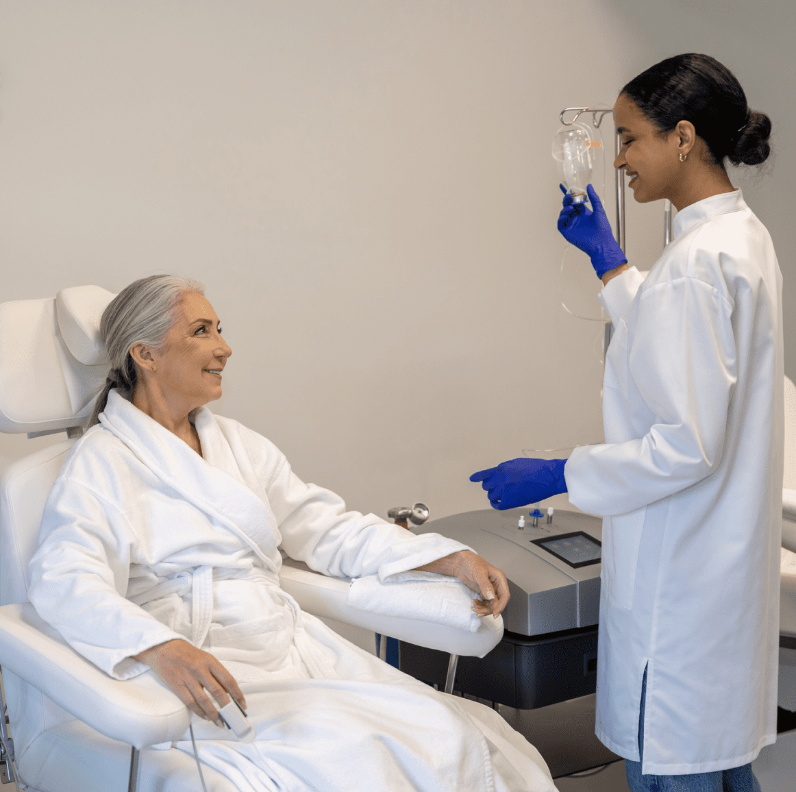 Patient receiving IV treatment from healthcare professional.